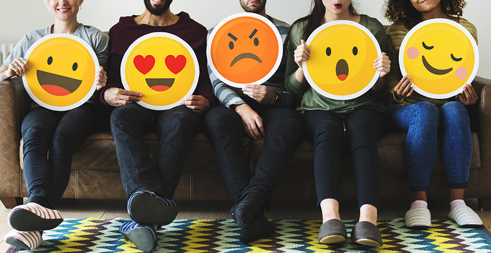 Group of diverse people holding emoticon icons how retailers use social media