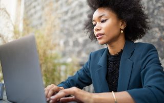 Close up businesswoman sitting with laptop computer at table