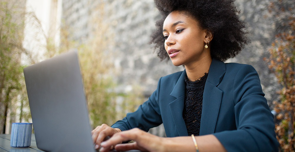 Close up businesswoman sitting with laptop computer at table